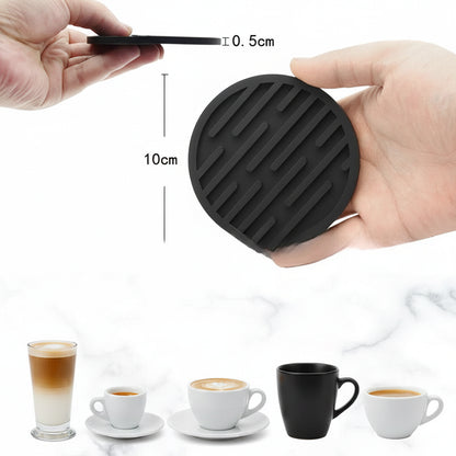 Black silicone coaster held by a hand with measurements, displayed next to different coffee cups