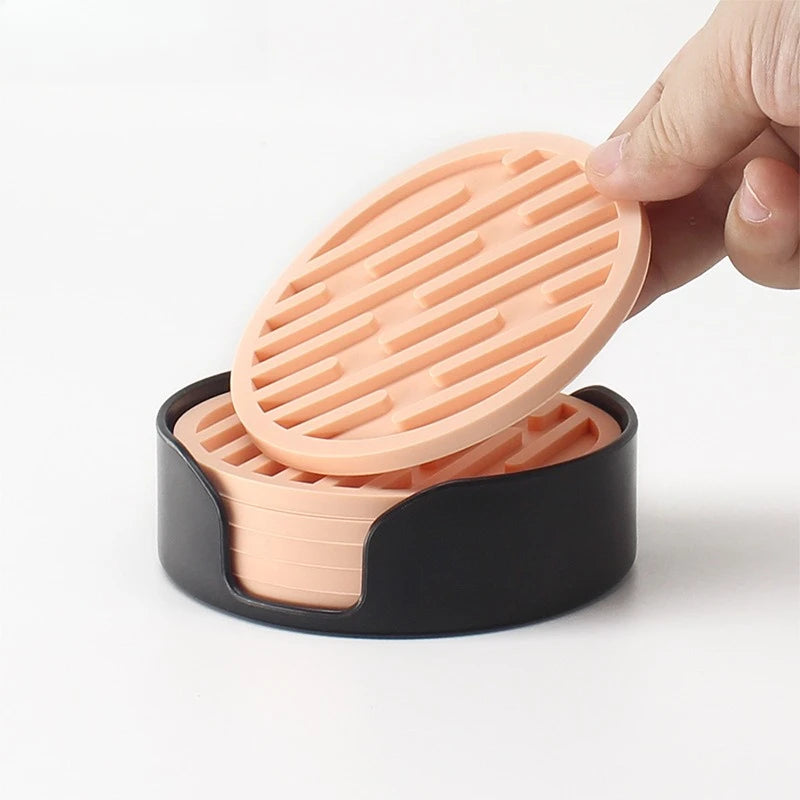 Pink silicone soap dish with a black base on a white background