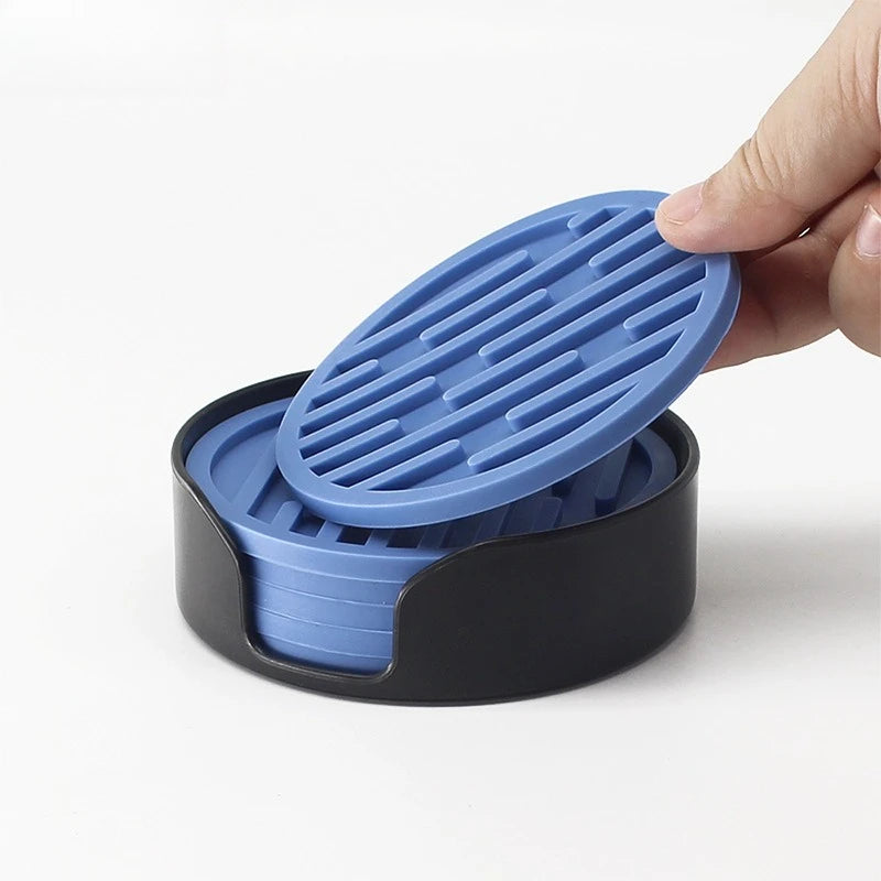 Blue silicone lid being placed on a black container by a hand against a white background
