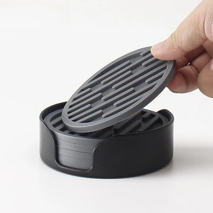 Gray and black plastic lid held by a hand on a white background