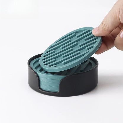 Hand holding a teal lid over a black container with stacked teal lids.