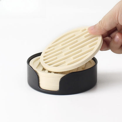 Hand holding a black and beige kitchen tool on a white background