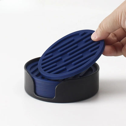 Hand holding a blue silicone lid over a black container on a white background