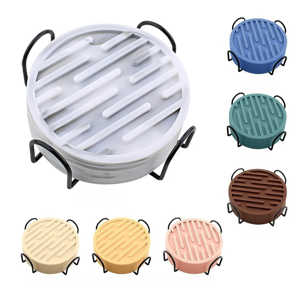 Set of round silicone coasters with handles in various colors on a white background