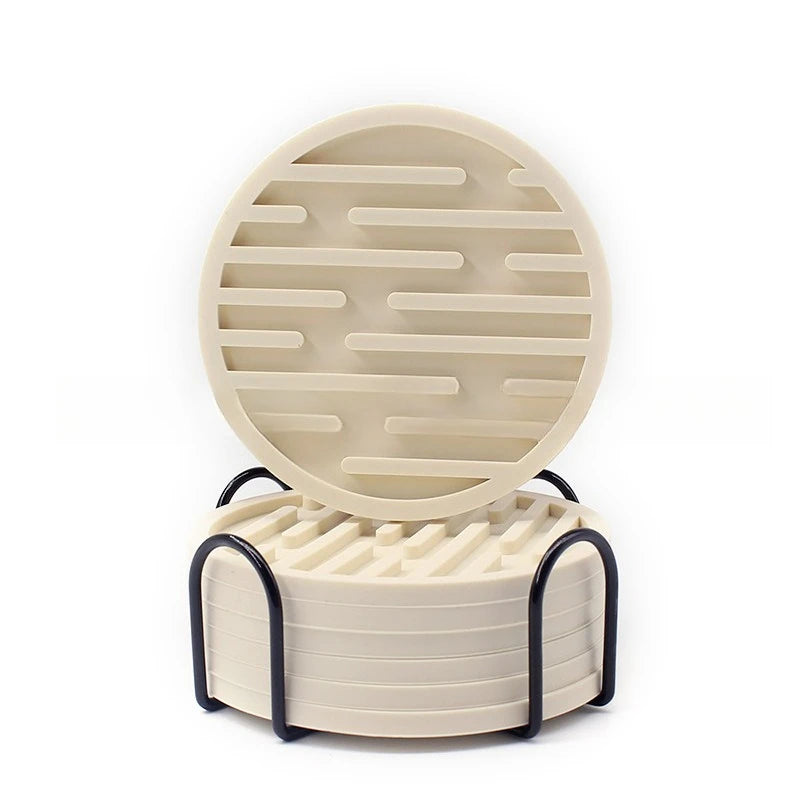 Round beige silicone coasters with a textured design on a white background
