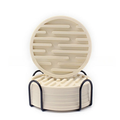 Round beige silicone coasters with a textured design on a white background