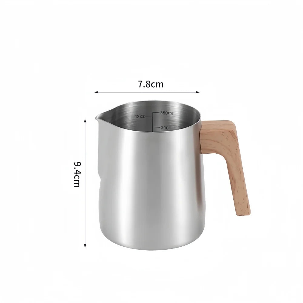 A stainless steel milk pitcher with a light wood handle, shown with dimension lines indicating a height of 9.4cm, a width of 7.