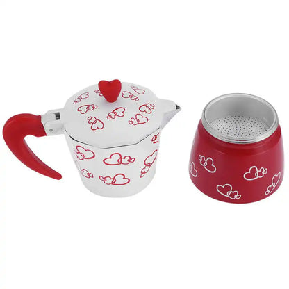 White teapot with red hearts and a matching red cup on a white background
