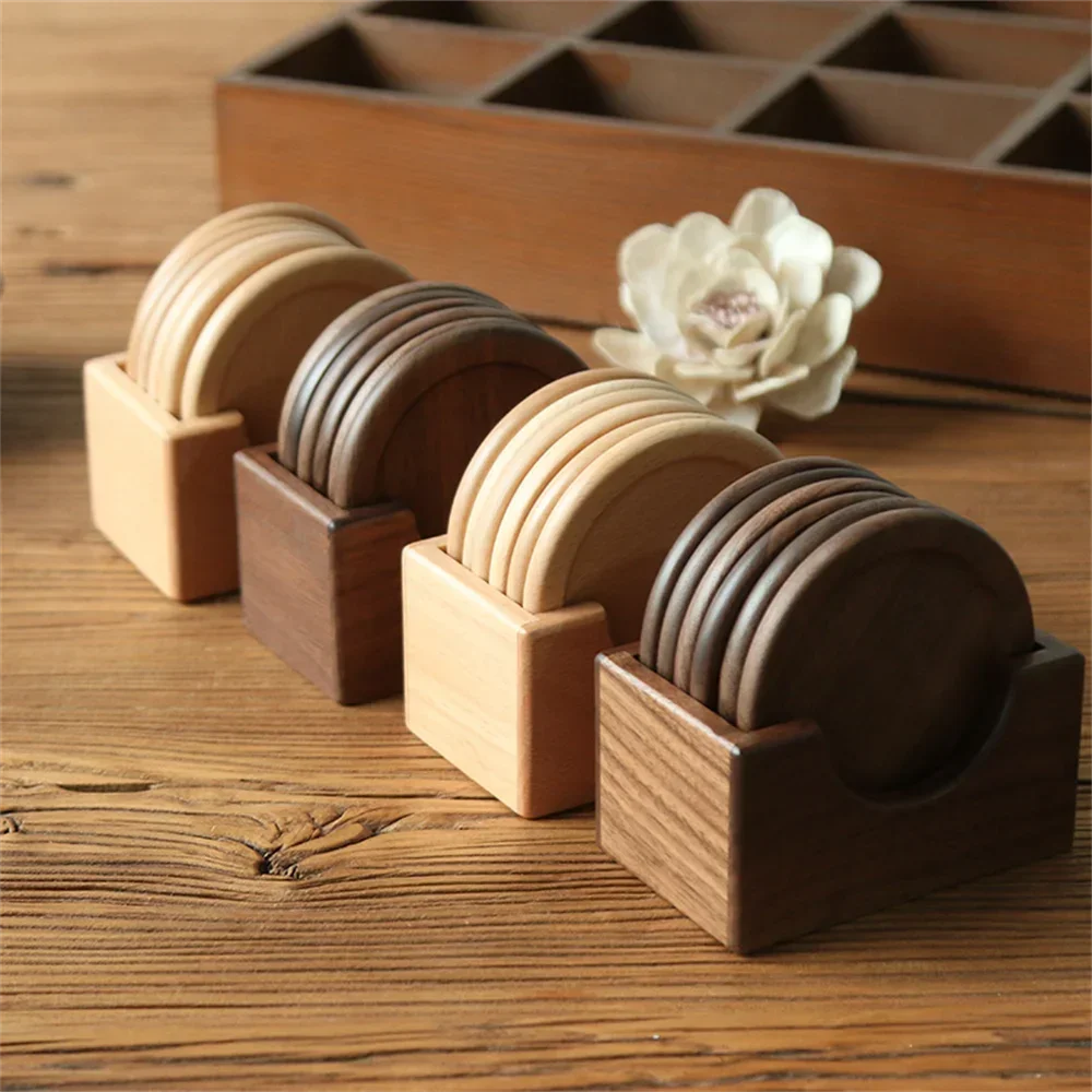 Set of wooden coasters in holders on a wooden surface