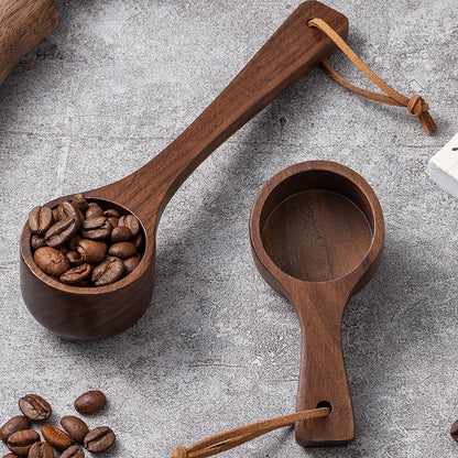 Wooden measuring spoons with coffee beans on a gray surface
