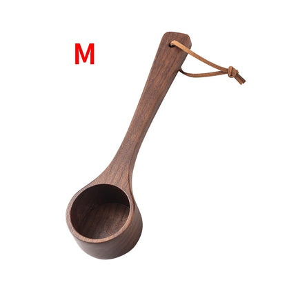 Wooden ladle with a long handle on a white background